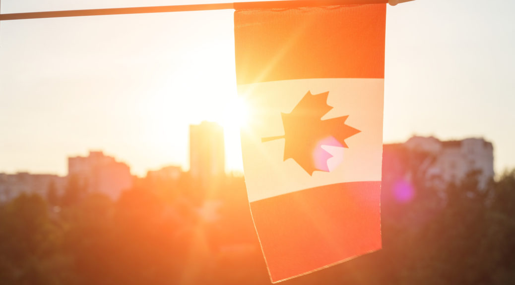 Flag of Canada from window on sunset background